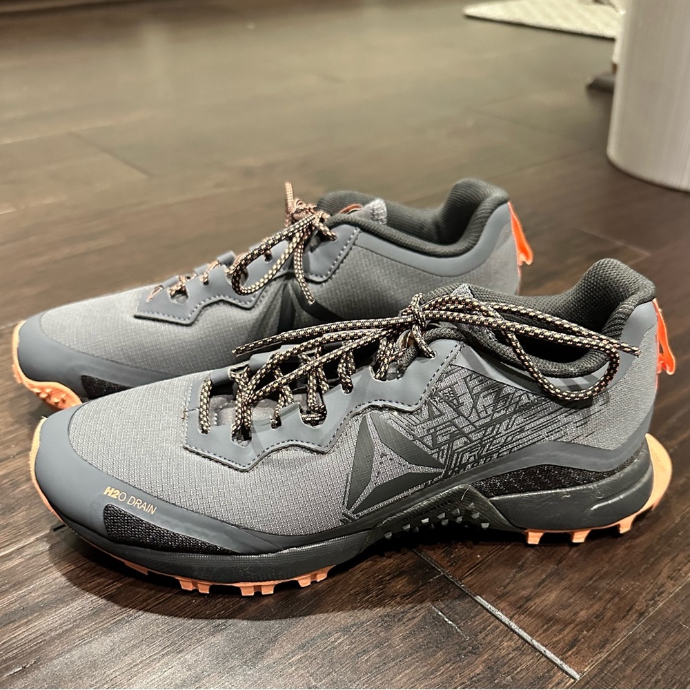 Gray and orange Reebok athletic sneakers